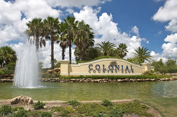 a view of swimming pool with lawn chairs and potted plants