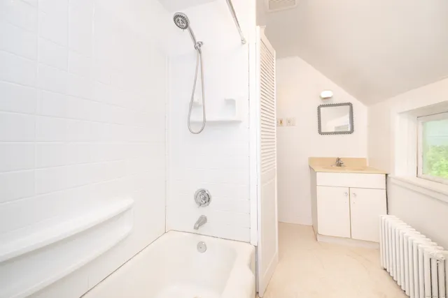 a bathroom with a bathtub and a shower