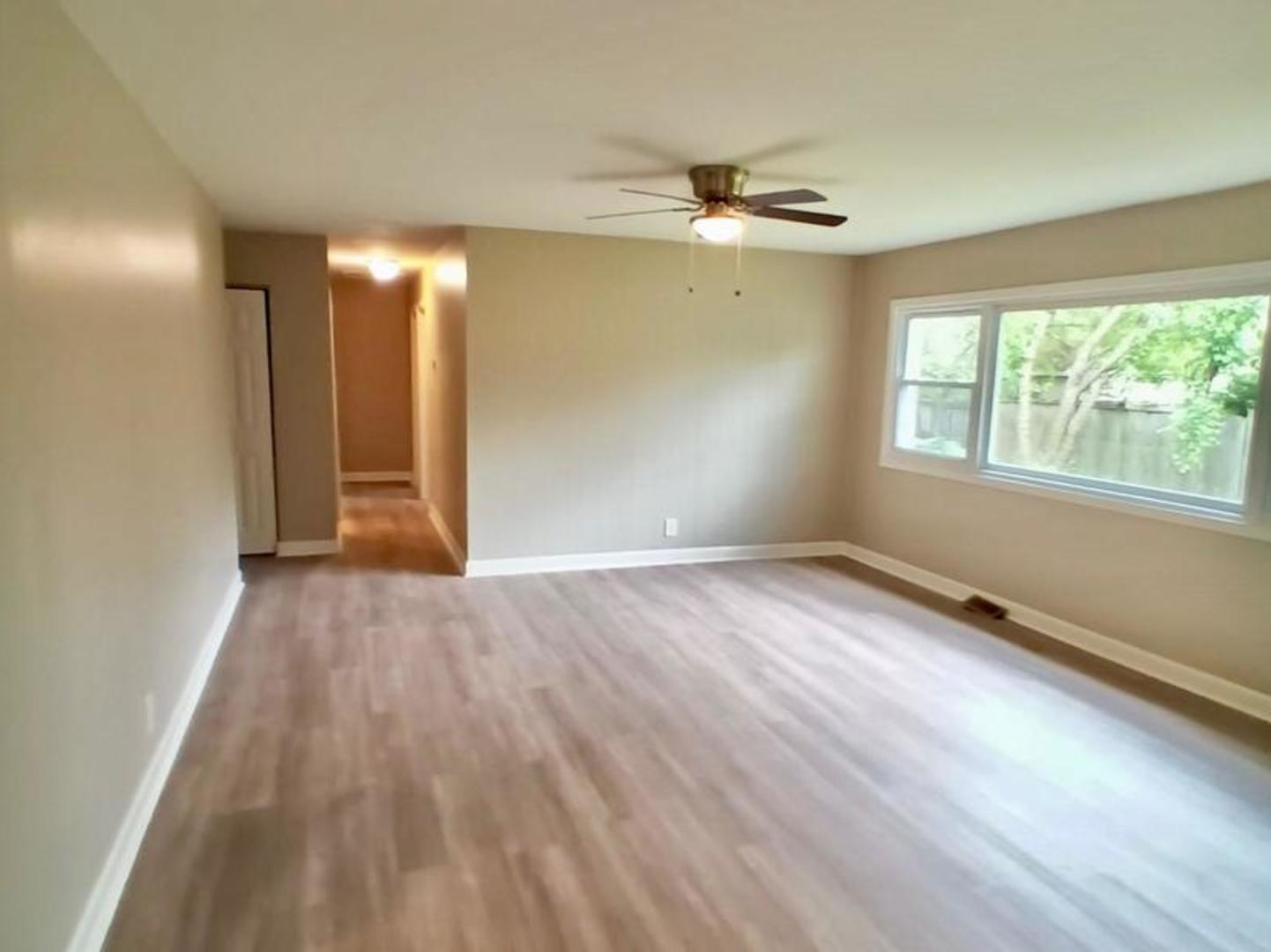 117 Kingston Road Bolingbrook, IL 60440 - Photo 13 of 24 an empty room with wooden floor and windows