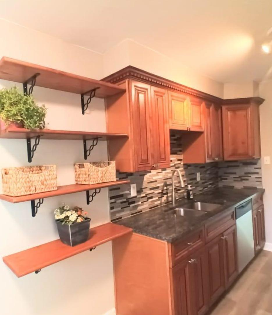 117 Kingston Road Bolingbrook, IL 60440 - Photo 3 of 24 a kitchen with a sink and cabinets