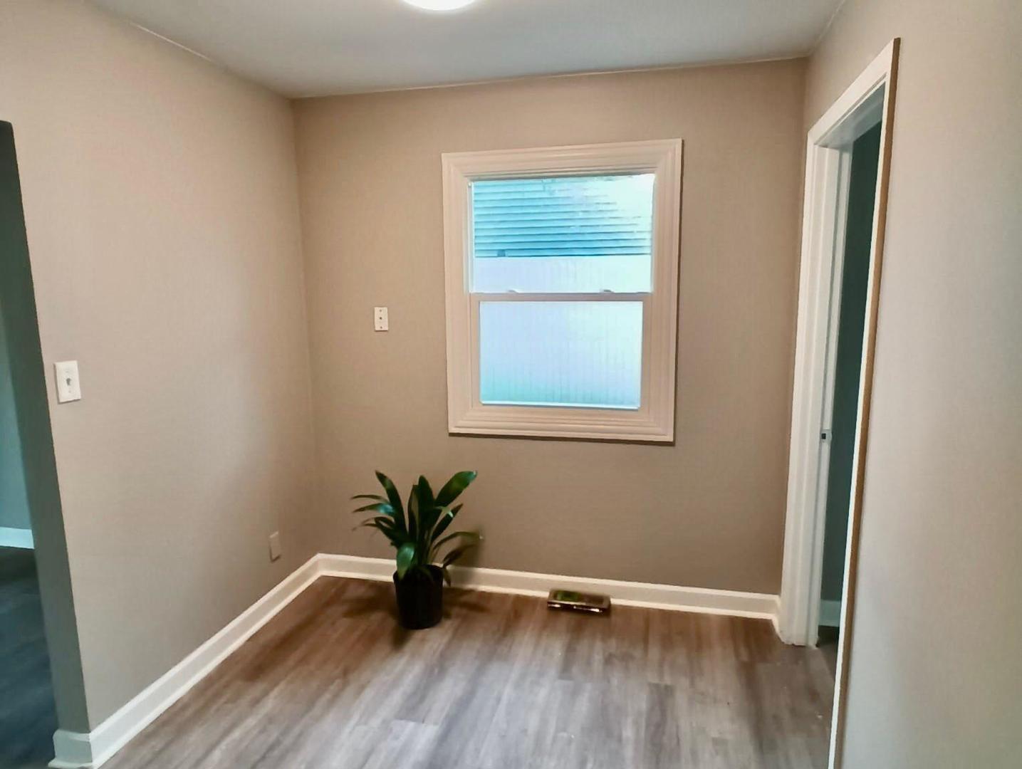 117 Kingston Road Bolingbrook, IL 60440 - Photo 5 of 24 an empty room with wooden floor and windows