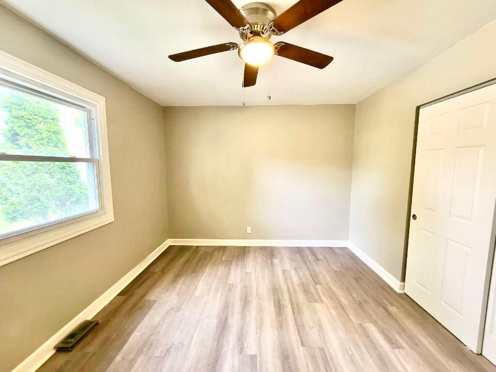 117 Kingston Road Bolingbrook, IL 60440 - Photo 9 of 24 an empty room with a window and a ceiling fan