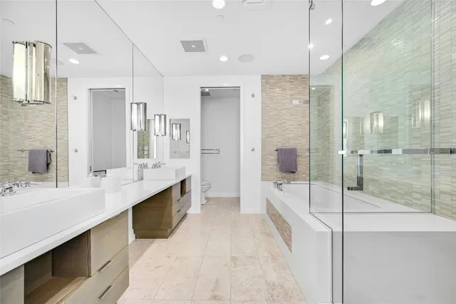 a spacious bathroom with a shower tub double sink and mirror