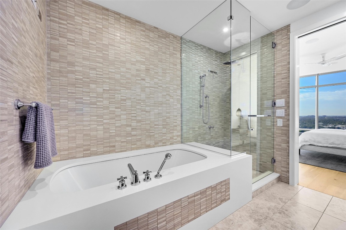 200 Congress Avenue, Unit 32SE Austin, TX 78701 - Photo 18 of 40 a spacious bathroom with a bathtub and shower