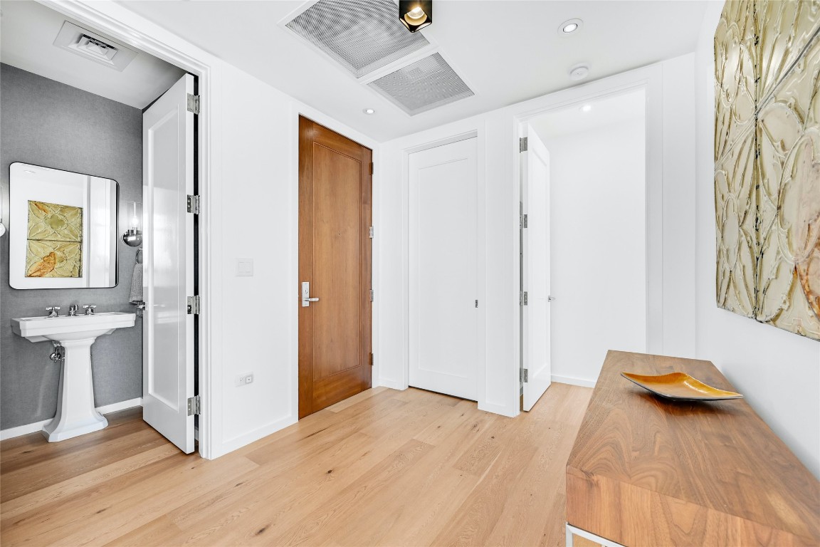 200 Congress Avenue, Unit 32SE Austin, TX 78701 - Photo 22 of 40 a view of a livingroom with wooden floor and closet