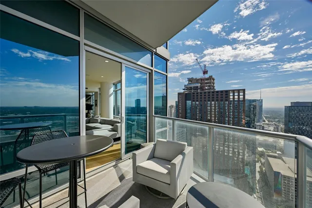 a balcony with table and chairs