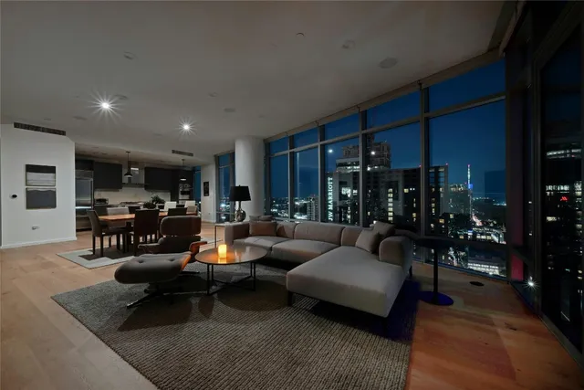 a living room with furniture kitchen view and a table
