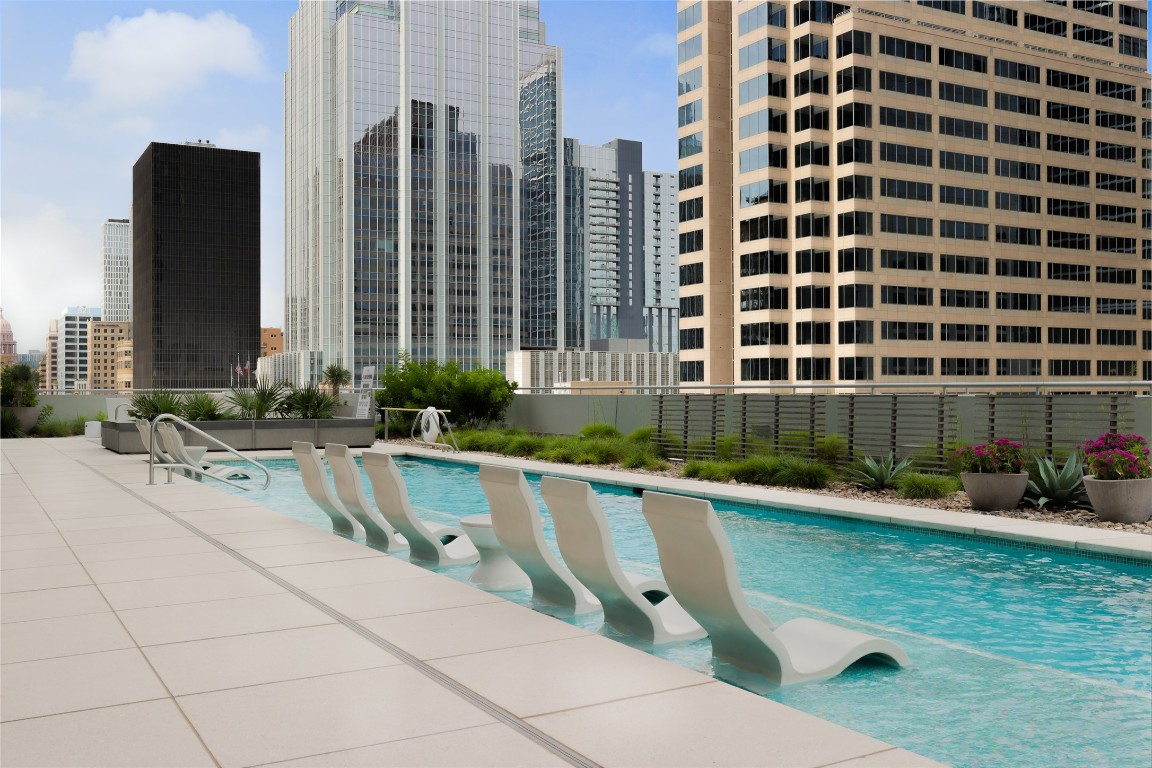200 Congress Avenue, Unit 32SE Austin, TX 78701 - Photo 39 of 40 a swimming pool with outdoor seating and yard