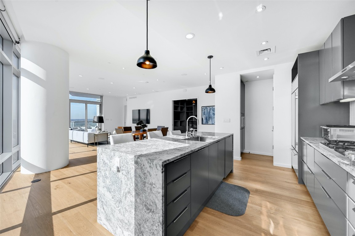 200 Congress Avenue, Unit 32SE Austin, TX 78701 - Photo 9 of 40 a kitchen with stainless steel appliances granite countertop a sink a stove and a refrigerator