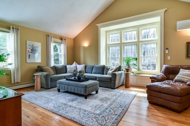 a view of a livingroom with workspace and a window