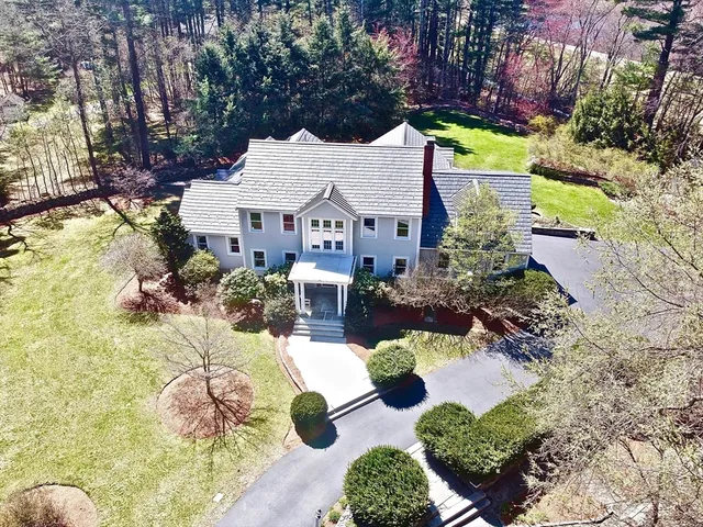 an aerial view of multiple houses with yard