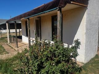 620 South 13th Street Slaton, TX 79364 - Photo 15 of 16 a couple of flower plants in front of door