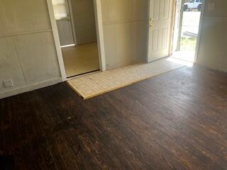 620 South 13th Street Slaton, TX 79364 - Photo 2 of 16 an empty room with wooden floor