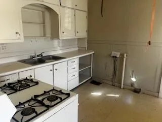 a kitchen with a sink stove and cabinets