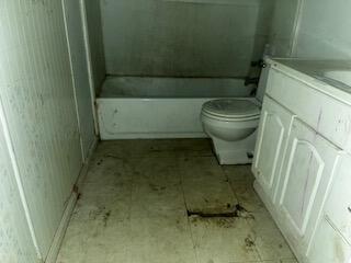 620 South 13th Street Slaton, TX 79364 - Photo 10 of 16 a bathroom with a sink and a toilet