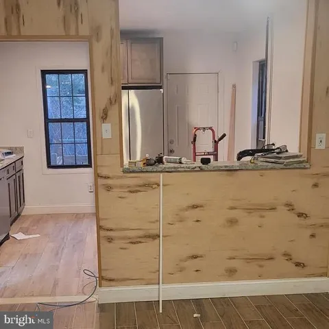 a kitchen with a stove a sink and a window