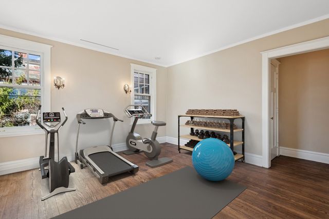 a view of an empty room with a fireplace and a window