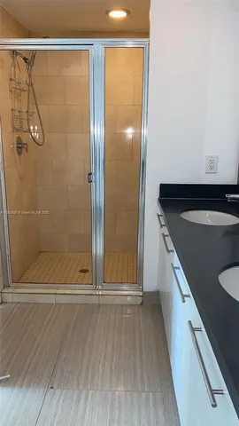 a bathroom with a shower and a sink
