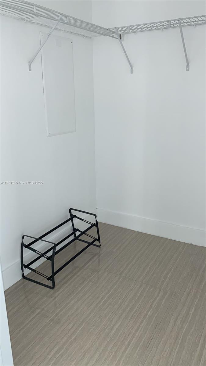 90 Southwest 3rd Street, Unit 3907 Miami, FL 33130 - Photo 16 of 31 a room with a bench and wooden floor