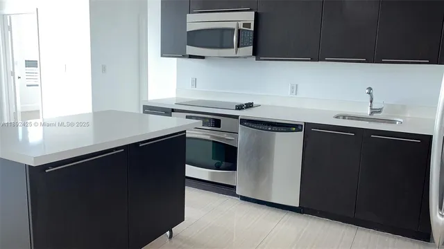 a kitchen with a sink and a microwave