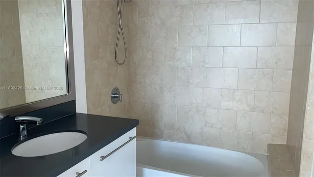 a bathroom with a granite countertop sink