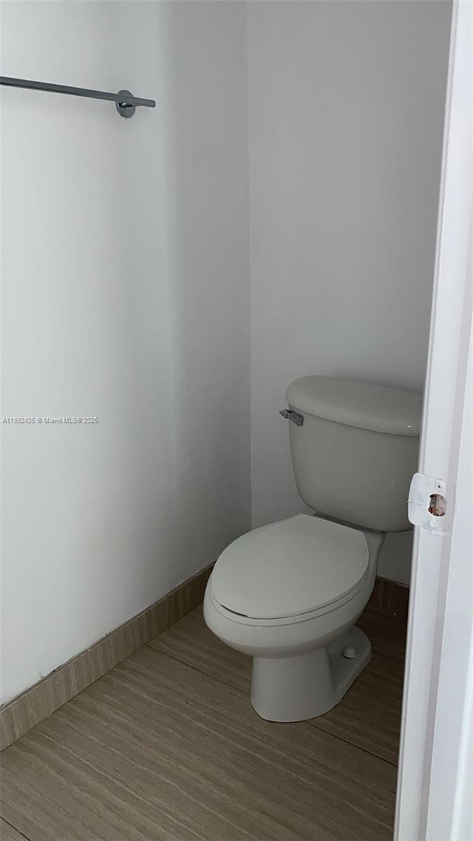 90 Southwest 3rd Street, Unit 3907 Miami, FL 33130 - Photo 10 of 31 a white toilet sitting next to a shower