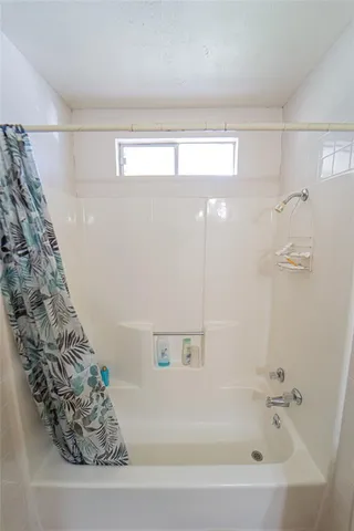 a bathroom with a bathtub and shower