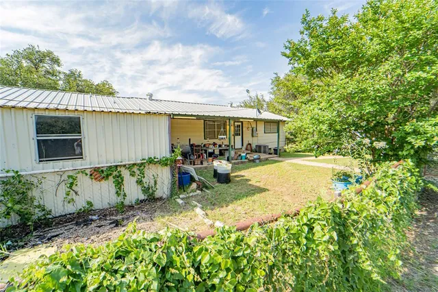 a view of swimming pool with outdoor seating and plants