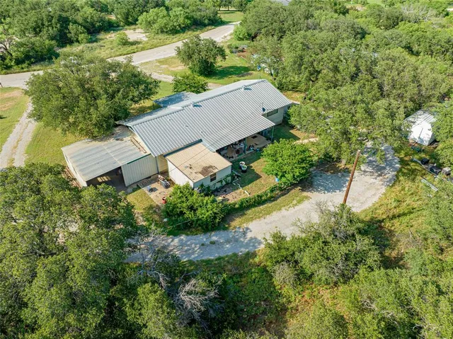 an aerial view of a house with yard and outdoor seating