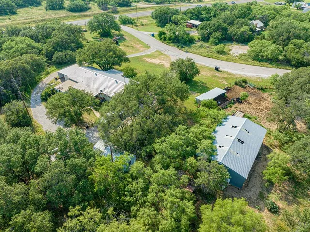 an aerial view of a house with a yard and outdoor seating