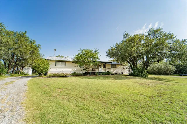 a view of a house with a yard and garage