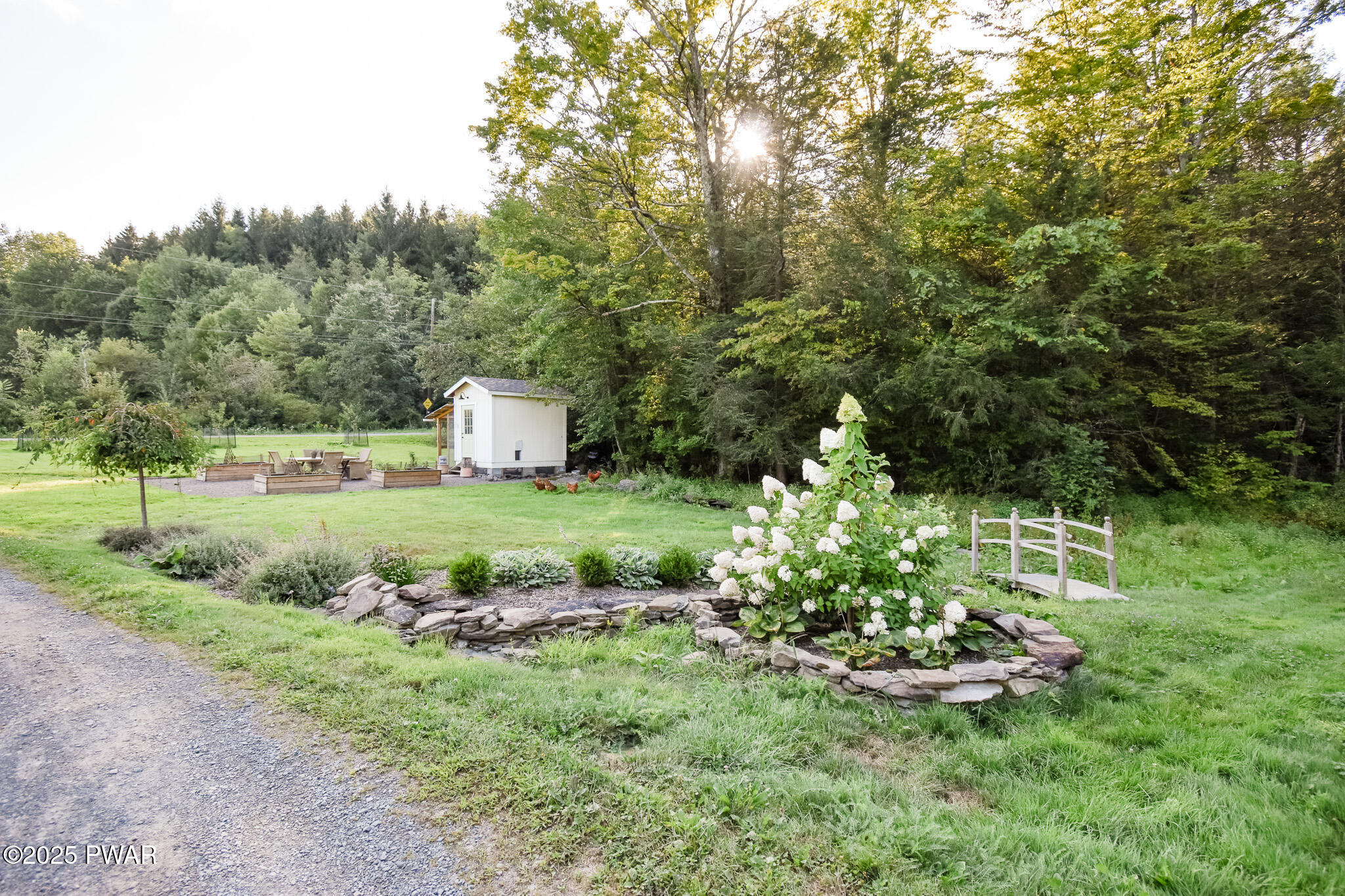 66 Wash Road Waymart, PA 18472 - Photo 24 of 41 a view of a garden with a fountain