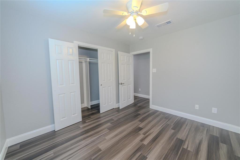 809 Wilcox Street McKinney, TX 75069 - Photo 18 of 26 Unfurnished bedroom featuring a closet, ceiling fan, and dark wood-style floors