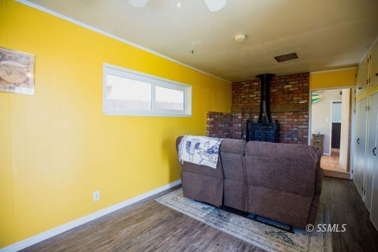 246 Peg Street Ridgecrest, CA 93555 - Photo 23 of 30 a living room with furniture and a floor to ceiling window