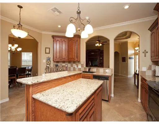 a dining hall with a dining table chairs and chandelier