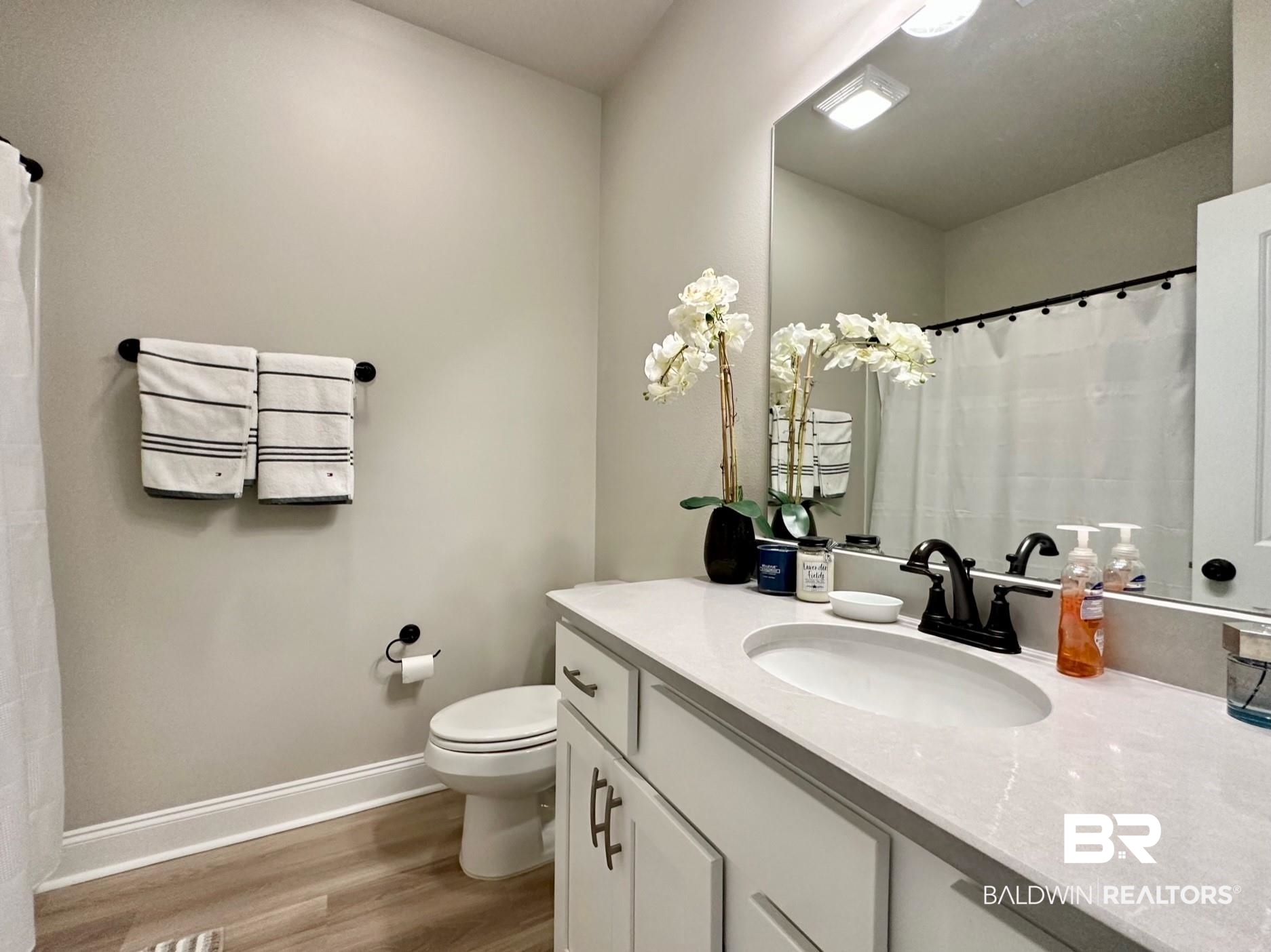 1009 Ruisseau Drive Foley, AL 36535 - Photo 49 of 55 Bathroom with vanity, toilet, and hardwood / wood-style flooring