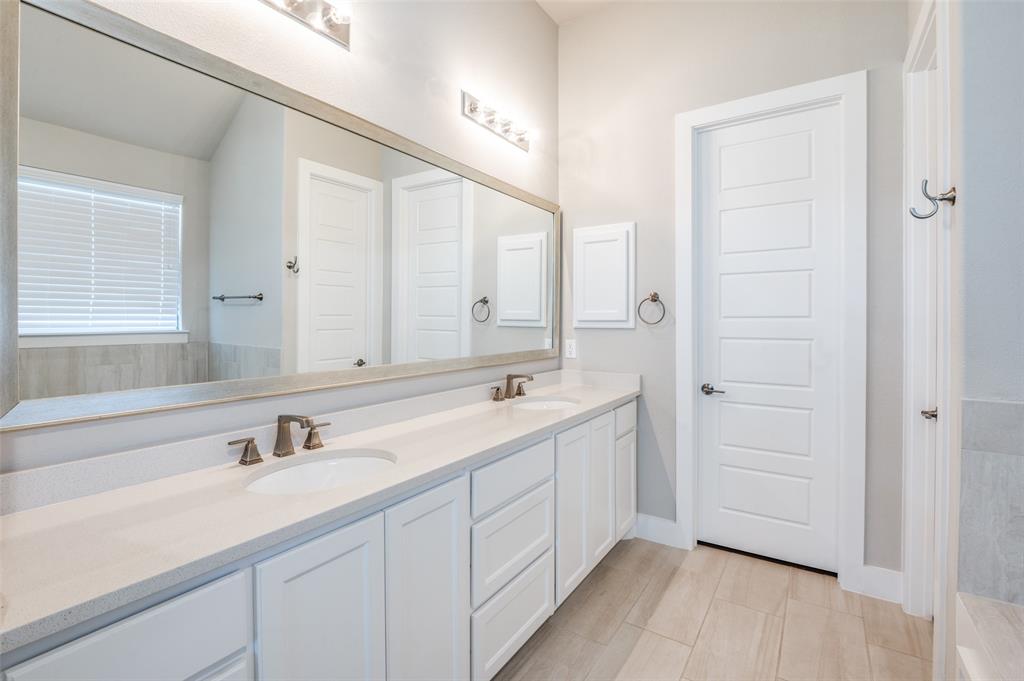 2901 Quinton Street Prosper, TX 75078 - Photo 14 of 27 a bathroom with a double vanity sink and mirror