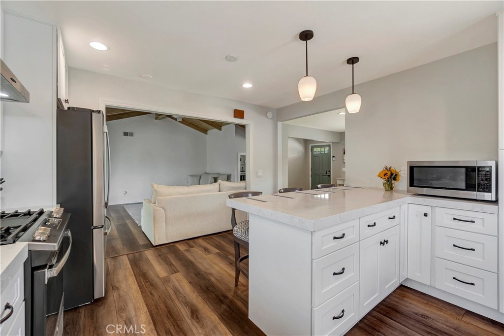 16243 Summershade Drive La Mirada, CA 90638 - Photo 13 of 34 a kitchen that has a lot of cabinets in it and wooden floors