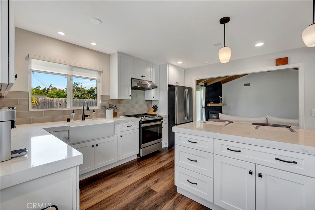 16243 Summershade Drive La Mirada, CA 90638 - Photo 14 of 34 a large white kitchen with a large window appliances and cabinets