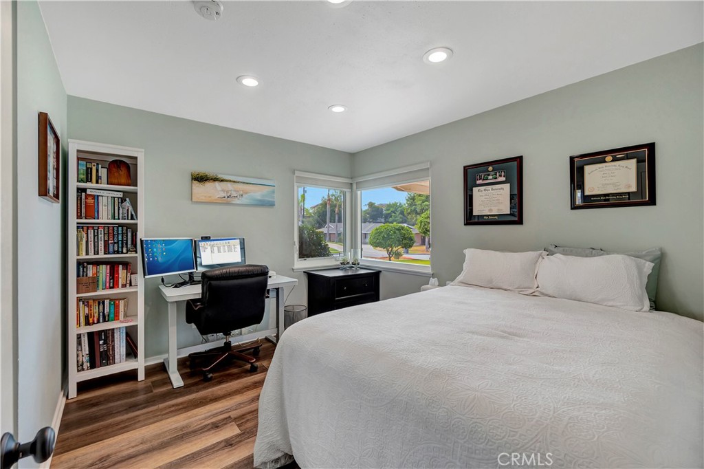 16243 Summershade Drive La Mirada, CA 90638 - Photo 21 of 34 a bedroom with a bed a table and a book shelf