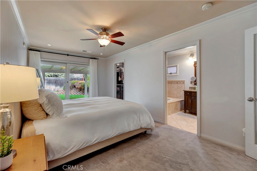 16243 Summershade Drive La Mirada, CA 90638 - Photo 26 of 34 a bedroom with a large bed and a chandelier
