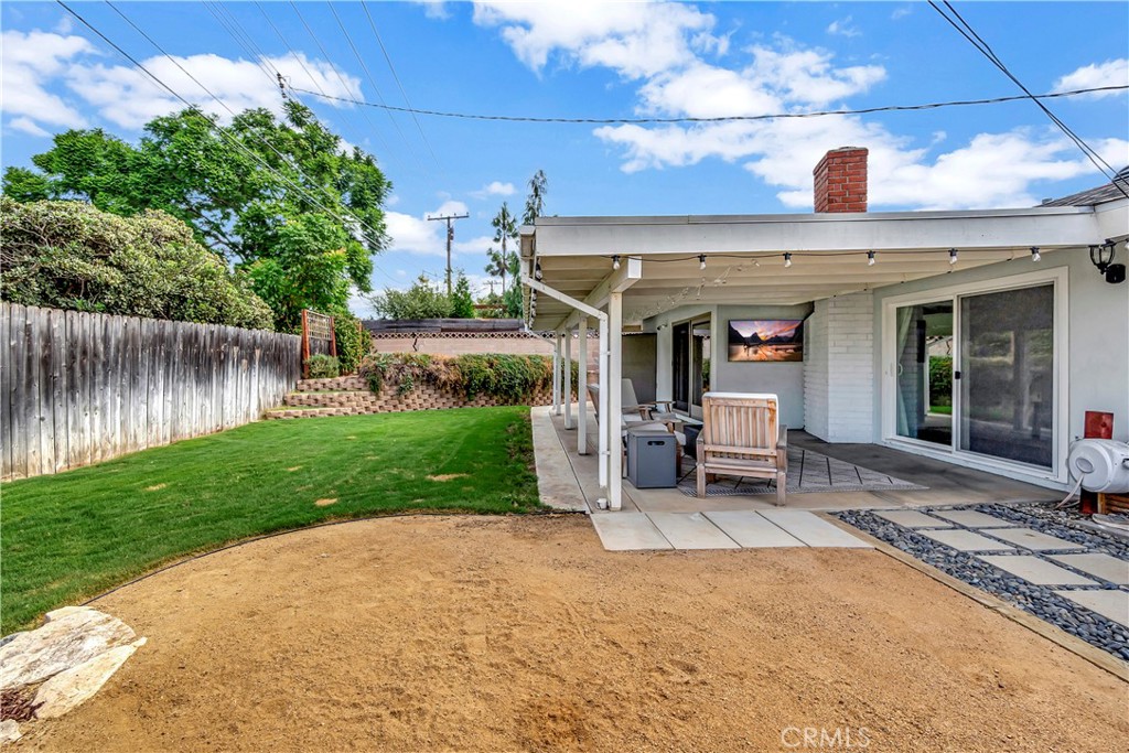 16243 Summershade Drive La Mirada, CA 90638 - Photo 30 of 34 a view of a patio with table and chairs potted plants with wooden fence