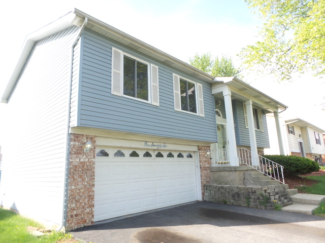 176 Grady Drive Bolingbrook, IL 60440 - Photo 2 of 30 a front view of a house with a garage