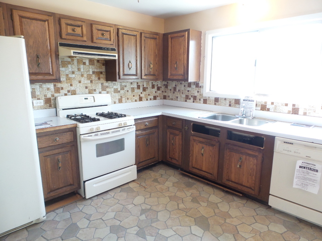 176 Grady Drive Bolingbrook, IL 60440 - Photo 12 of 30 a kitchen with a stove sink and cabinets