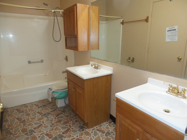 176 Grady Drive Bolingbrook, IL 60440 - Photo 15 of 30 a bathroom with a sink a toilet and shower