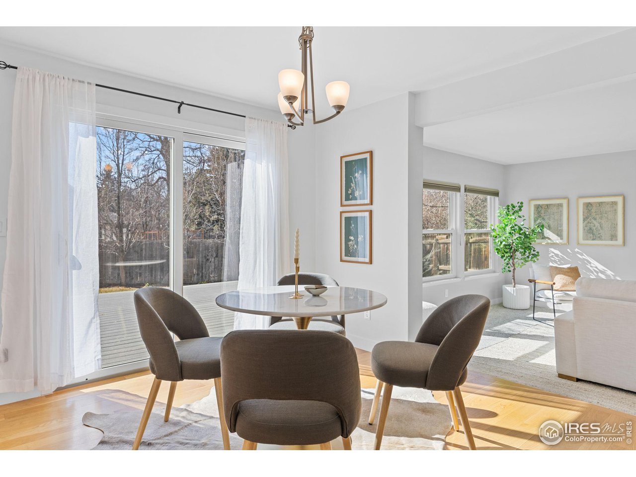 4302 Apple Way Boulder, CO 80301 - Photo 12 of 38 a dining room with furniture a chandelier and wooden floor