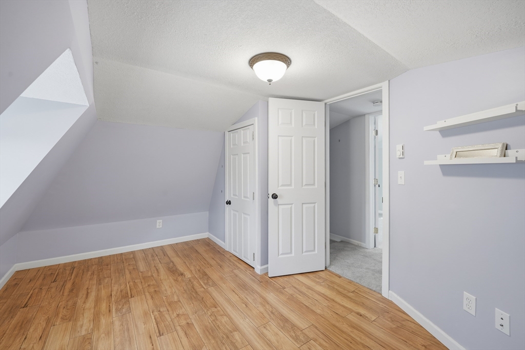 196 Pendleton Avenue Chicopee, MA 01020 - Photo 16 of 22 a view of an empty room with wooden floor and a window