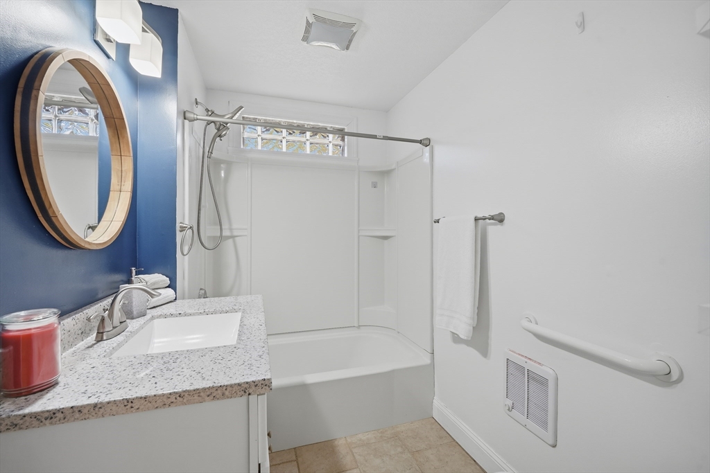 196 Pendleton Avenue Chicopee, MA 01020 - Photo 5 of 22 a bathroom with a granite countertop sink mirror toilet and bathtub
