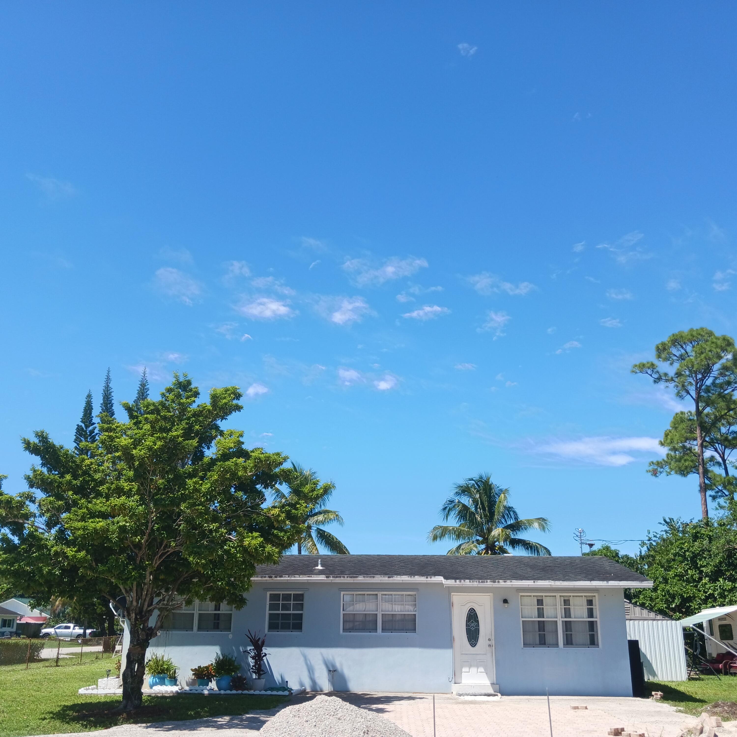 5783 Mango Road Royal Palm Estates, FL 33413 - Photo 3 of 47 a view of residential houses with yard and entertaining space