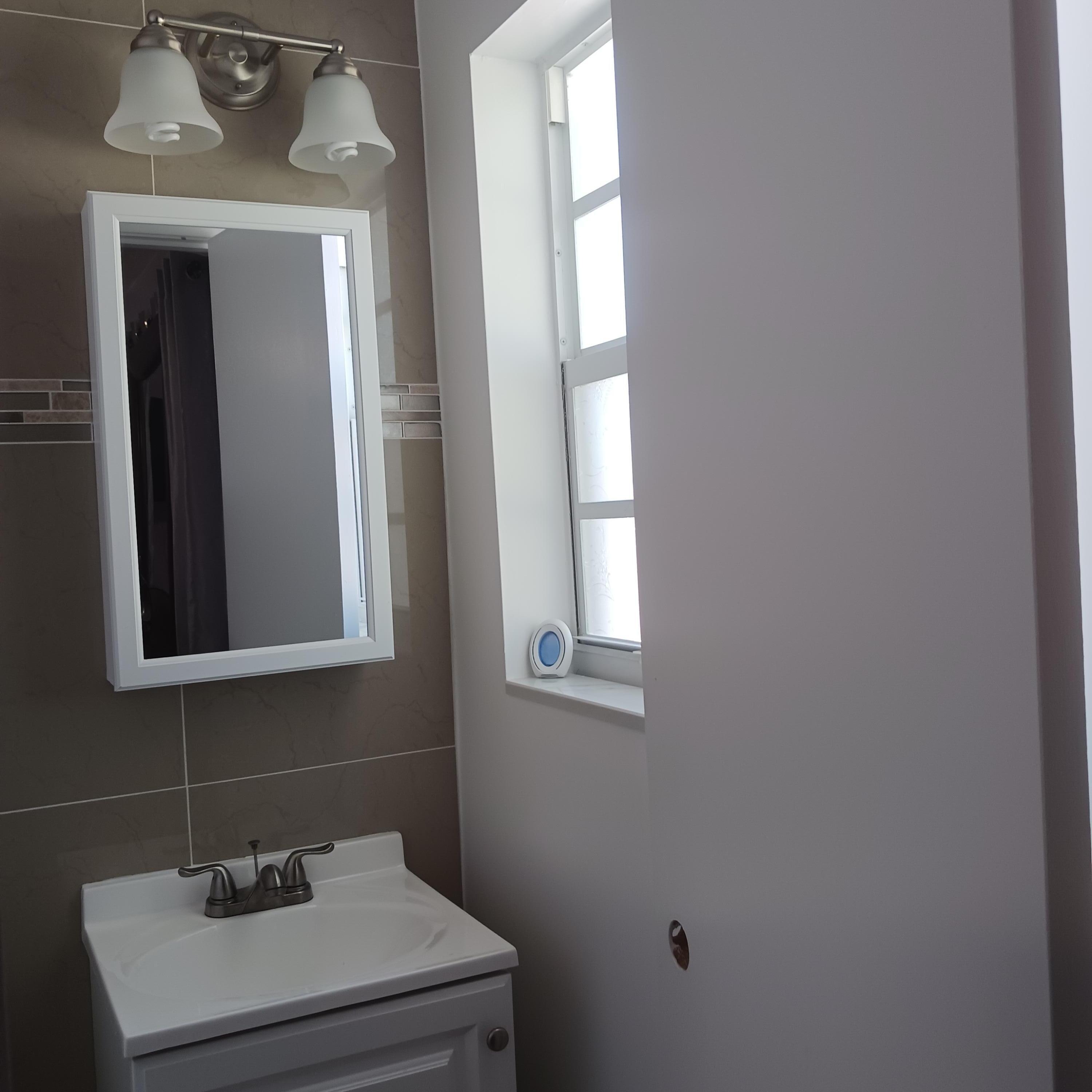 5783 Mango Road Royal Palm Estates, FL 33413 - Photo 36 of 47 a bathroom with a sink and a mirror